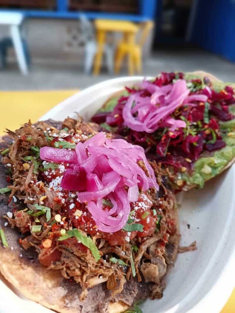 Crispy corn tostada shell topped with proteins.